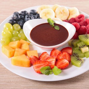 crème de chocolat entouré de fruits coupés